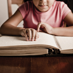 Educational Services for Blind and Visually Impaired Children - Application child with book (braille).